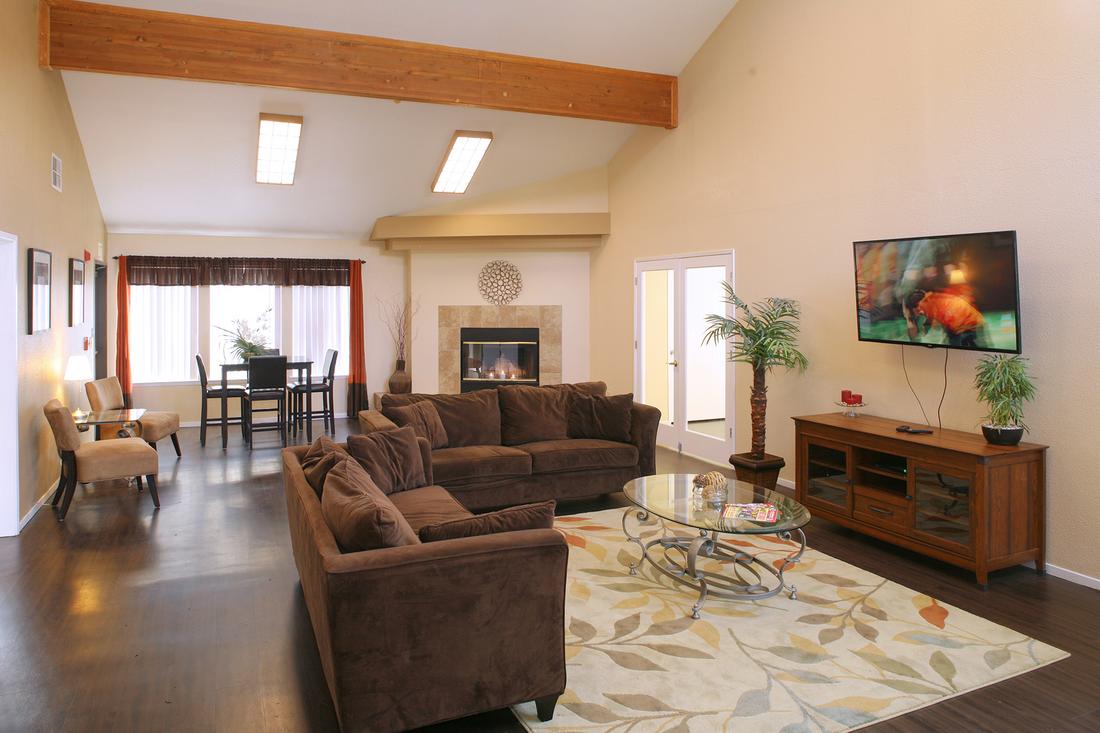 a living room filled with furniture and a flat screen tv.