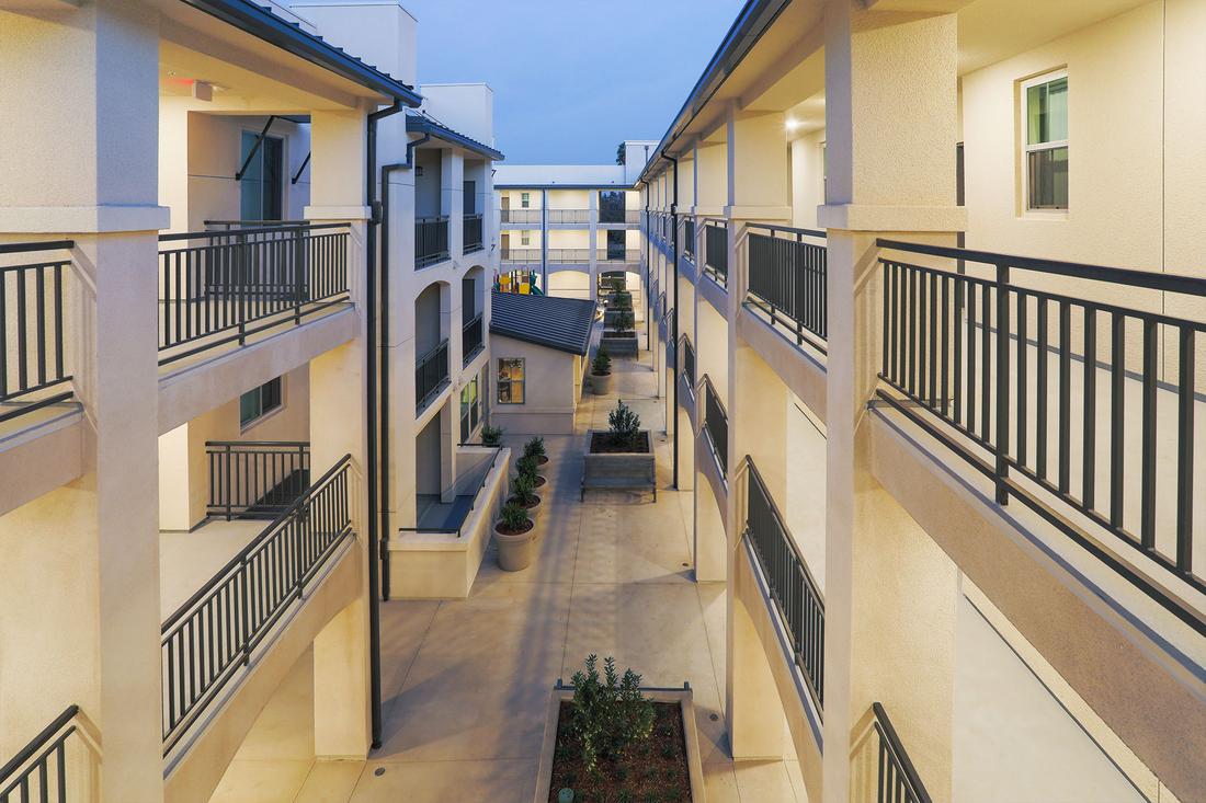 an apartment building with balconies and balconies on the second floor.