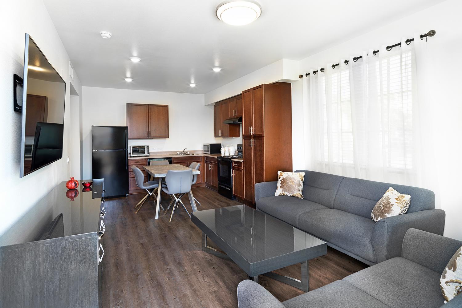 a living room filled with furniture and a flat screen tv.