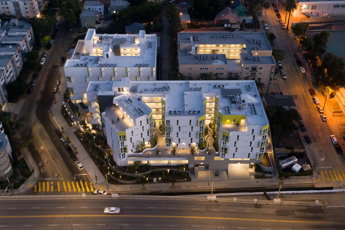an aerial view of a white building at night.