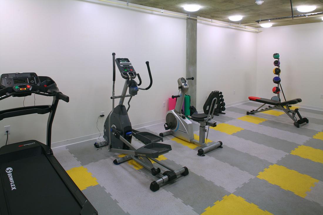 a gym with a variety of exercise equipment.