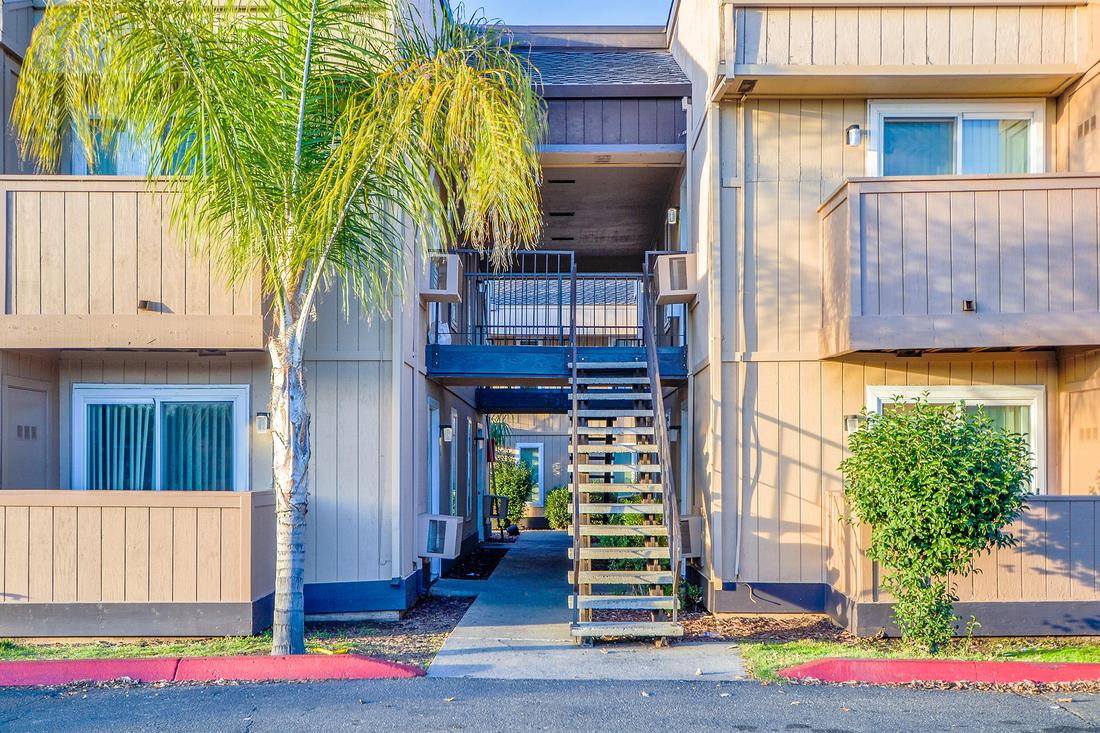 an apartment building with a staircase leading to the second floor.